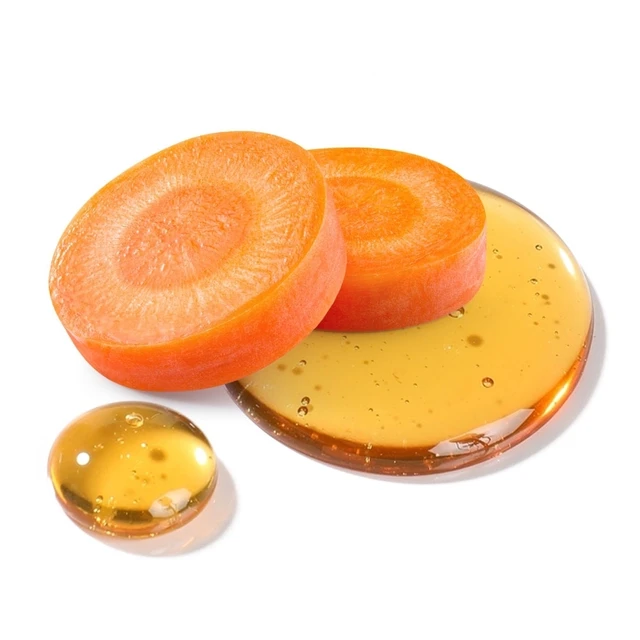 Two round orange fruit slices resting on a pool of golden honey with a small honey drop nearby.