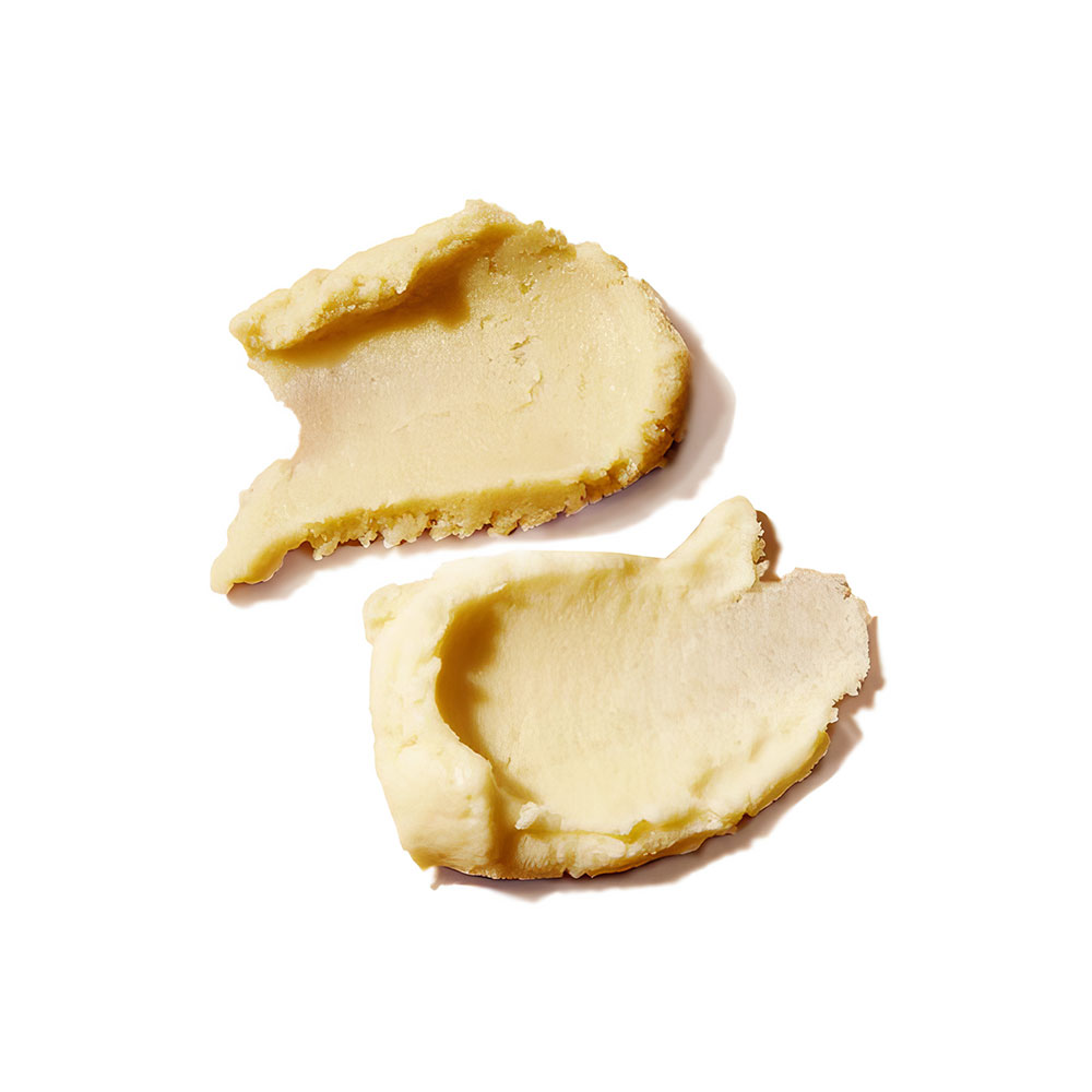 Two large pieces of unsalted butter on a white background.